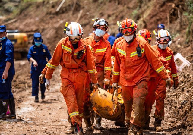 Disaster relief personnel help transfer materials